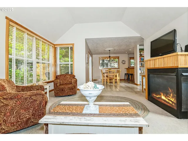 a living room with fireplace furniture and a flat screen tv