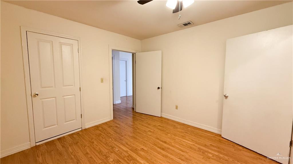 21713 North Western Road Edinburg, TX 78541 - Photo 13 of 24 Unfurnished bedroom with light wood-type flooring and ceiling fan
