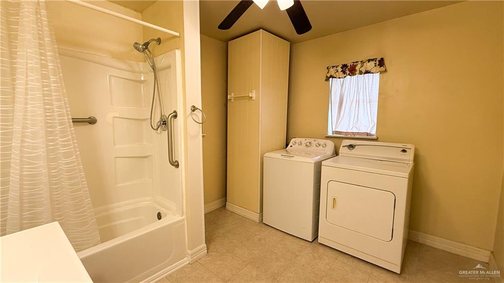 21713 North Western Road Edinburg, TX 78541 - Photo 14 of 24 Full bath featuring shower / bath combo with shower curtain, separate washer and dryer, a ceiling fan, light flooring, and vanity