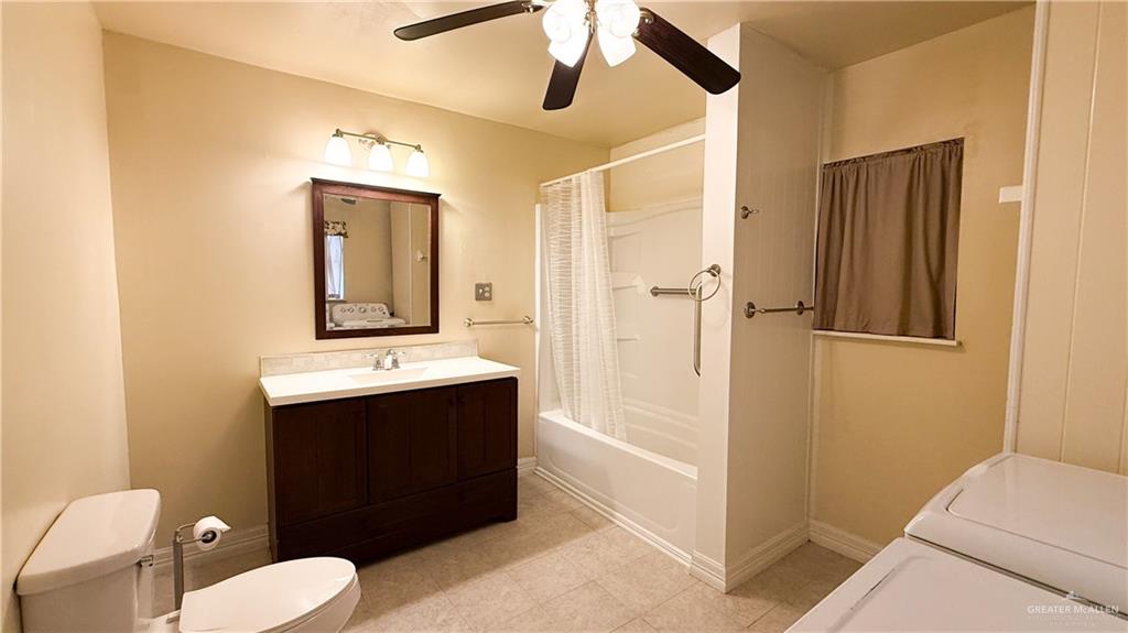 21713 North Western Road Edinburg, TX 78541 - Photo 15 of 24 Full bathroom with vanity, ceiling fan, and shower / bathtub combination with curtain
