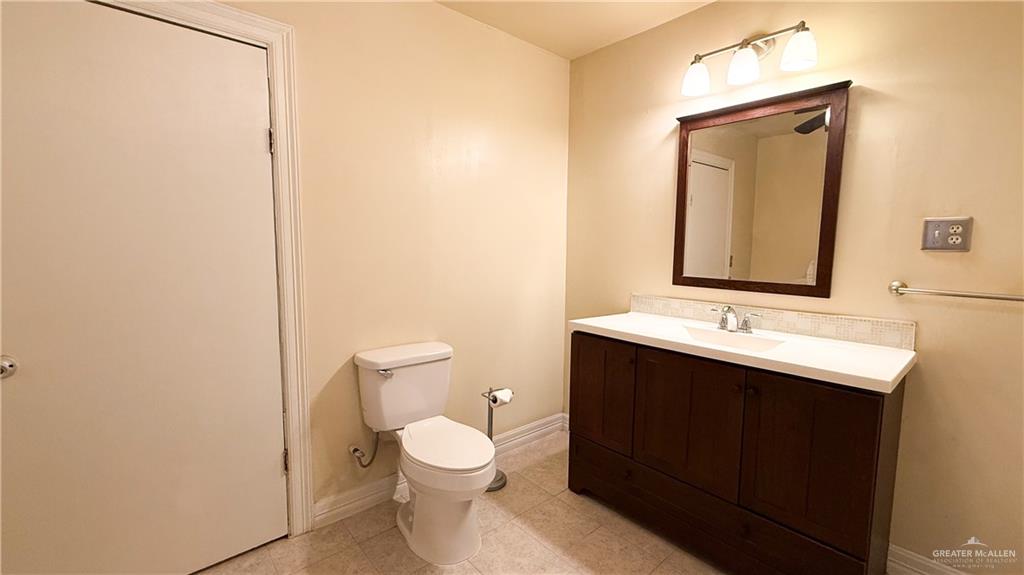 21713 North Western Road Edinburg, TX 78541 - Photo 17 of 24 Half bathroom with toilet and vanity