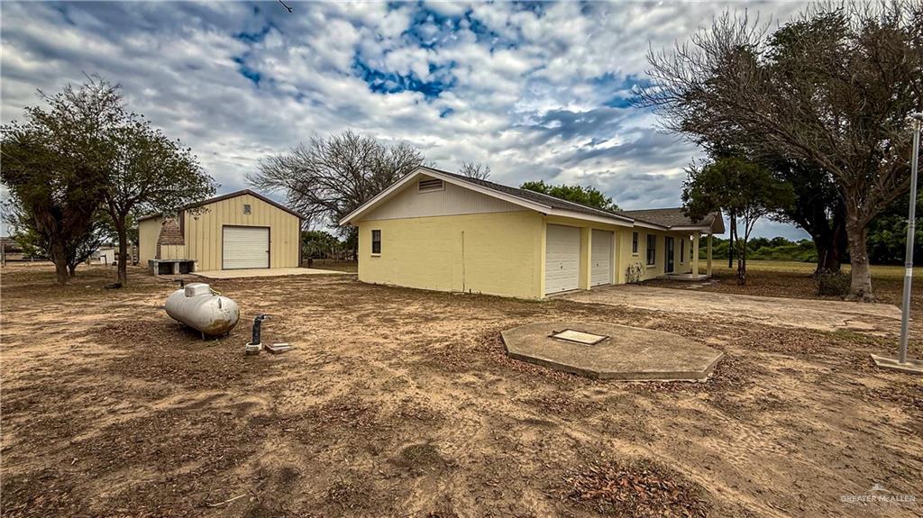 21713 North Western Road Edinburg, TX 78541 - Photo 23 of 24 View of side of home with a detached garage and an outdoor structure