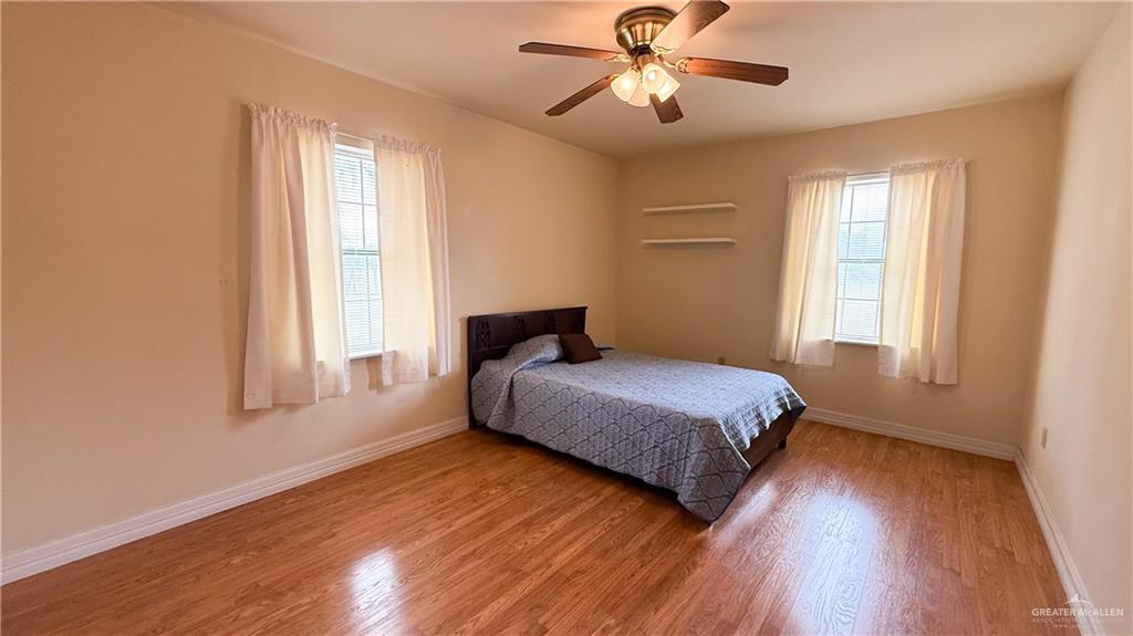 21713 North Western Road Edinburg, TX 78541 - Photo 9 of 24 Bedroom with wood finished floors and ceiling fan