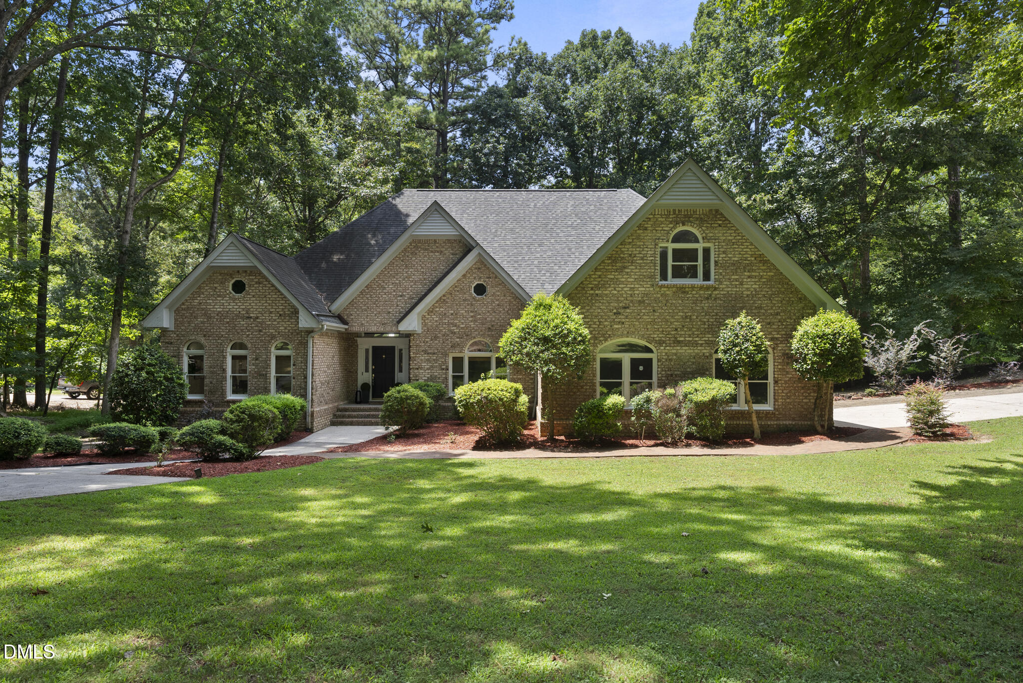 a front view of a house with a yard and sitting area