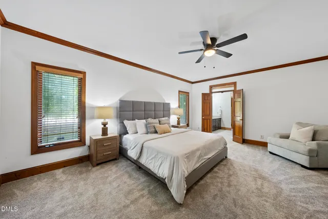 a bedroom with a bed couches and window