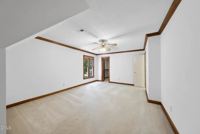 a view of a livingroom with a ceiling fan and window
