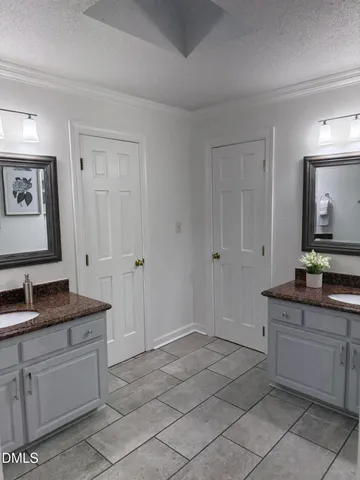 a spacious bathroom with a granite countertop sink and a mirror