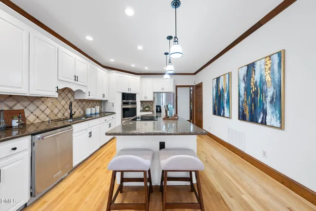 a kitchen with stainless steel appliances granite countertop counter space a sink and cabinets