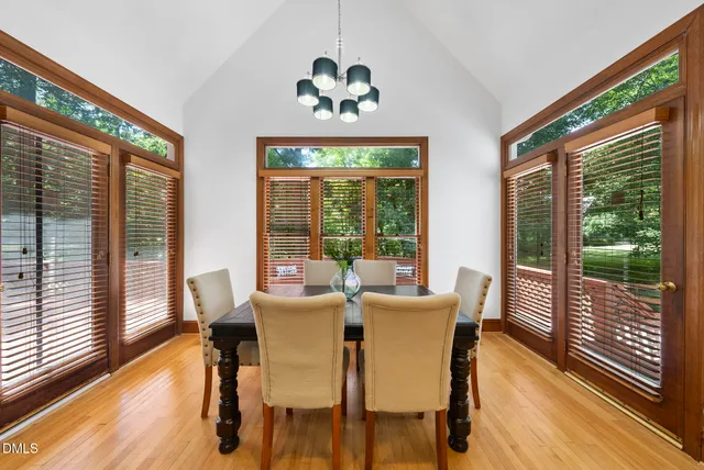 a view of a dining room with furniture large windows and wooden floor