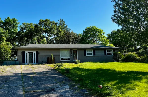 a view of a house with swimming pool in front of yard