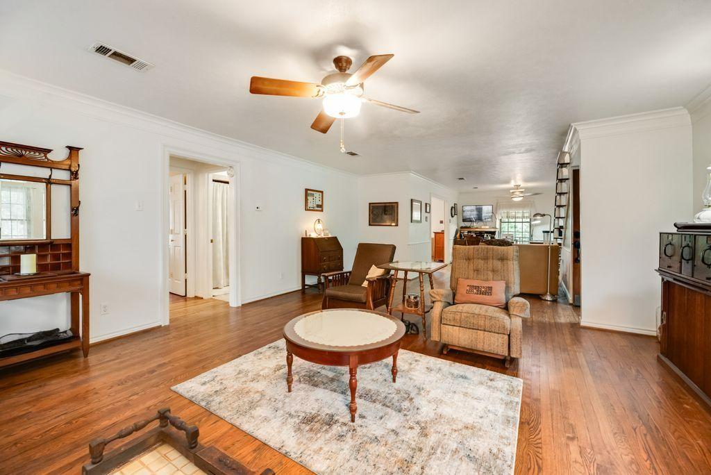 9875 Old Bridge Road Terrell, TX 75160 - Photo 16 of 40 a living room with furniture a mirror and a chandelier
