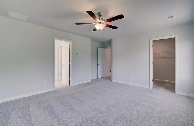 a view of an empty room with a ceiling fan