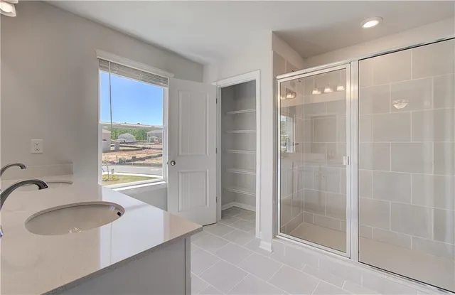 a bathroom with a shower sink and mirror