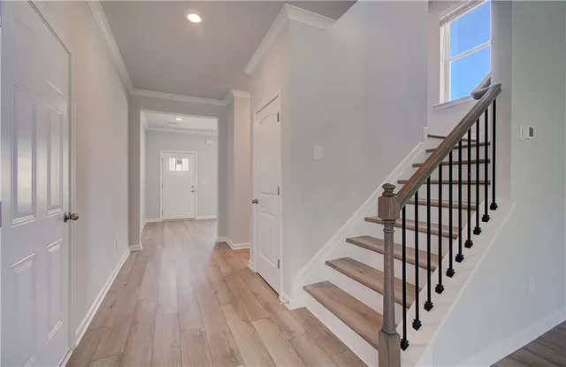 a view of a hallway with wooden floor and entryway