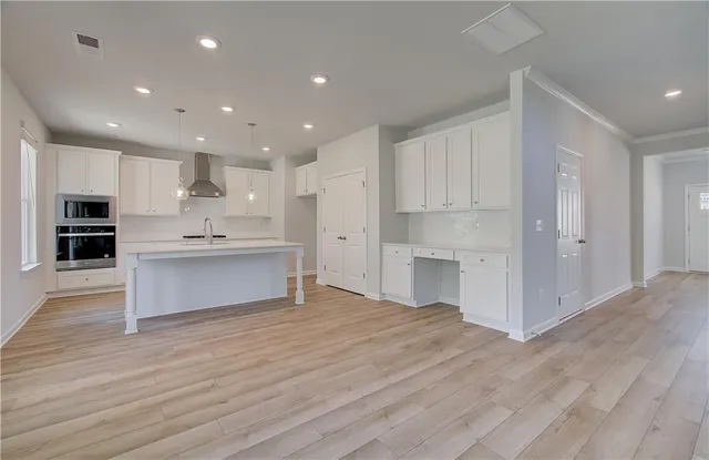 a view of kitchen with kitchen island cabinets and wooden floor