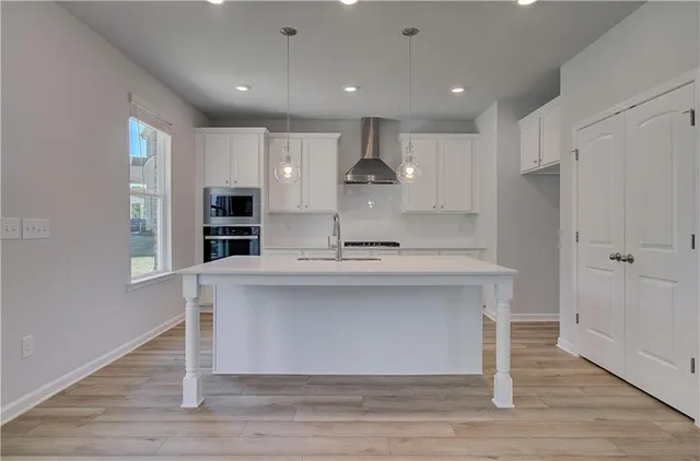 a view of kitchen with stainless steel appliances refrigerator sink and cabinets