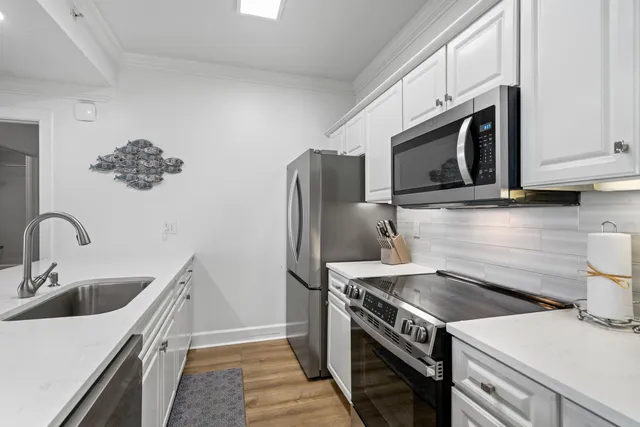 a kitchen with a sink and a stove top oven