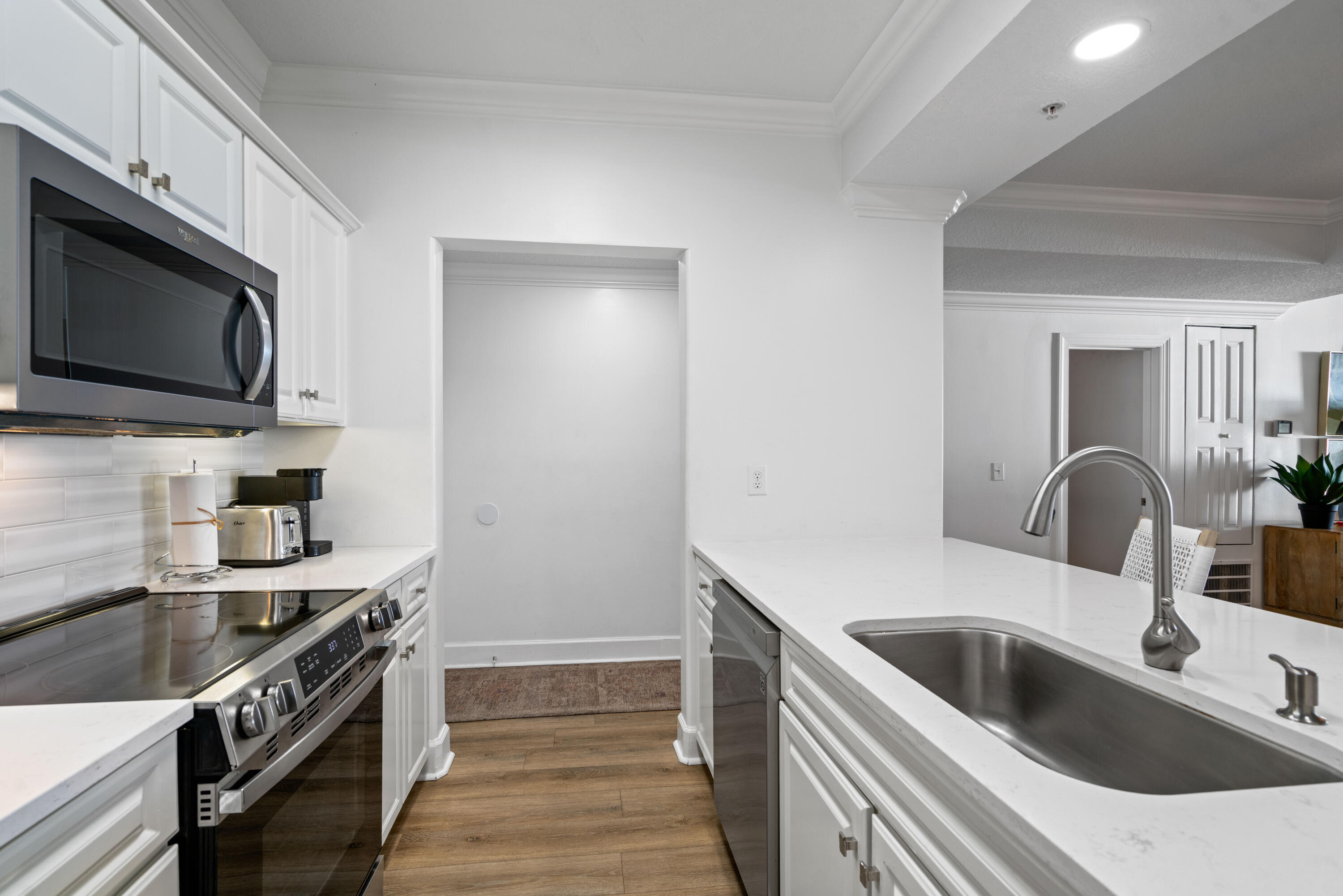 10611 Front Beach Road, Unit 303 Panama City Beach, FL 32408 - Photo 12 of 51 a kitchen with a sink and a stove top oven