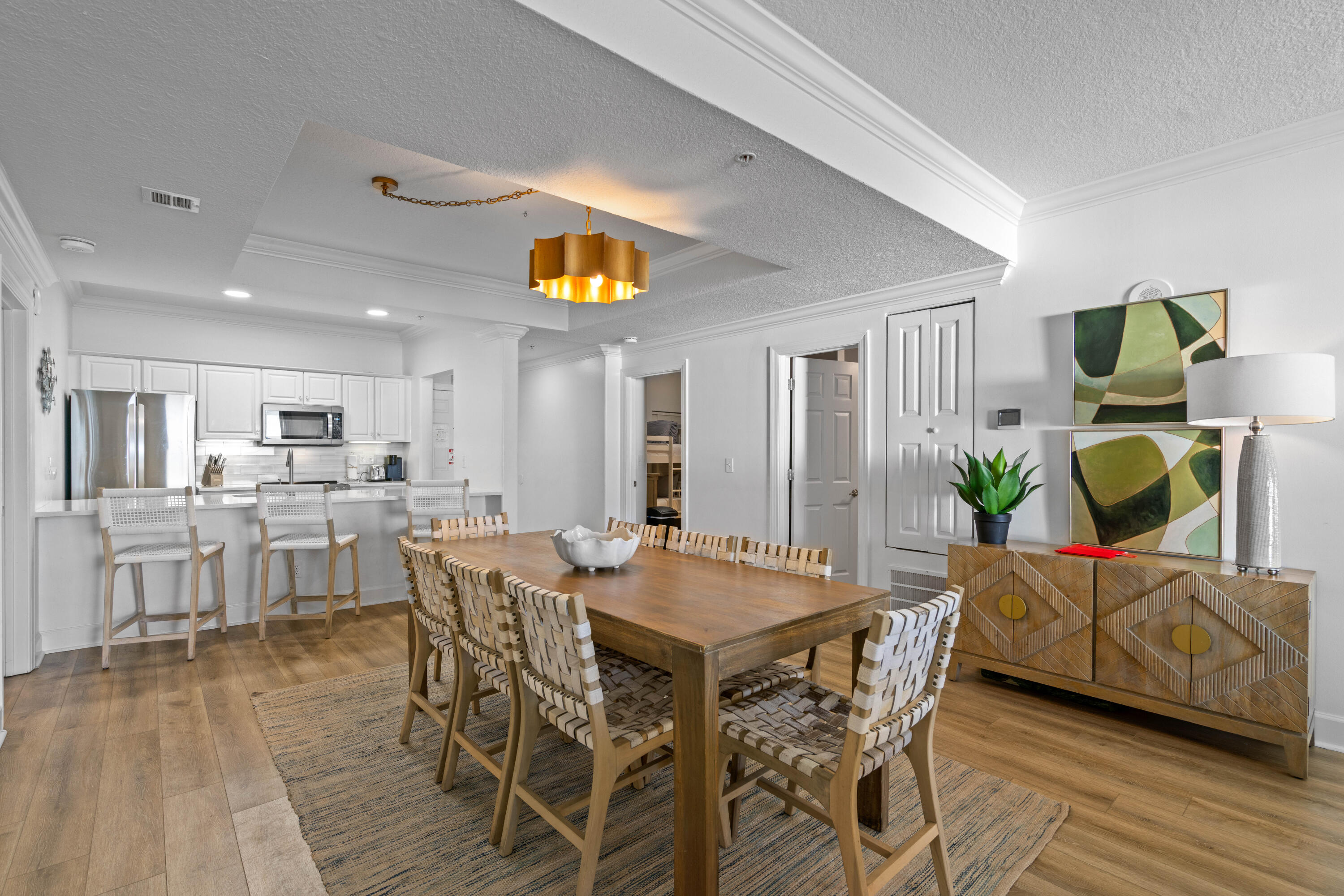 10611 Front Beach Road, Unit 303 Panama City Beach, FL 32408 - Photo 14 of 51 a view of a dining room with furniture and wooden floor