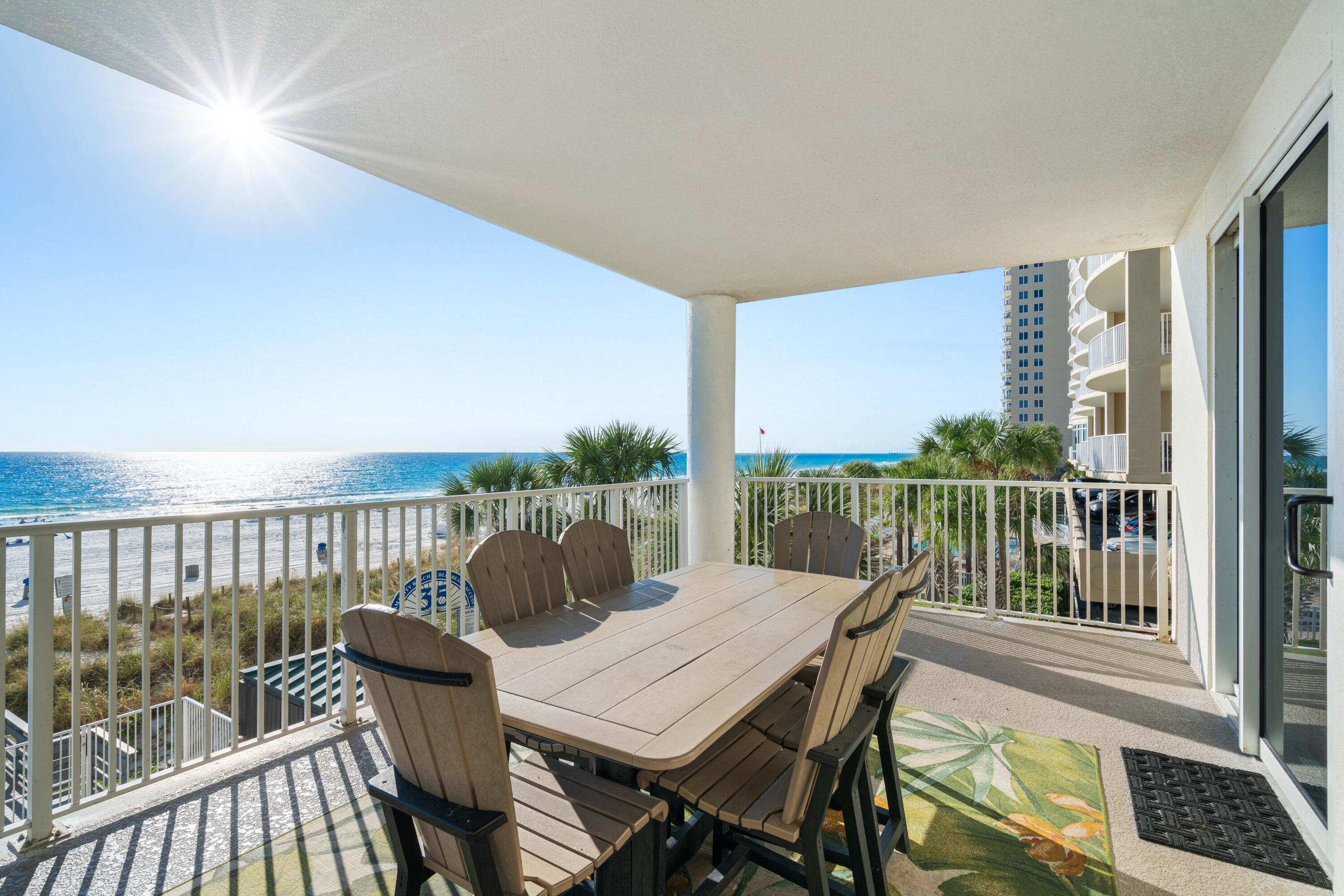 10611 Front Beach Road, Unit 303 Panama City Beach, FL 32408 - Photo 19 of 51 a balcony with wooden floor outdoor seating and city view