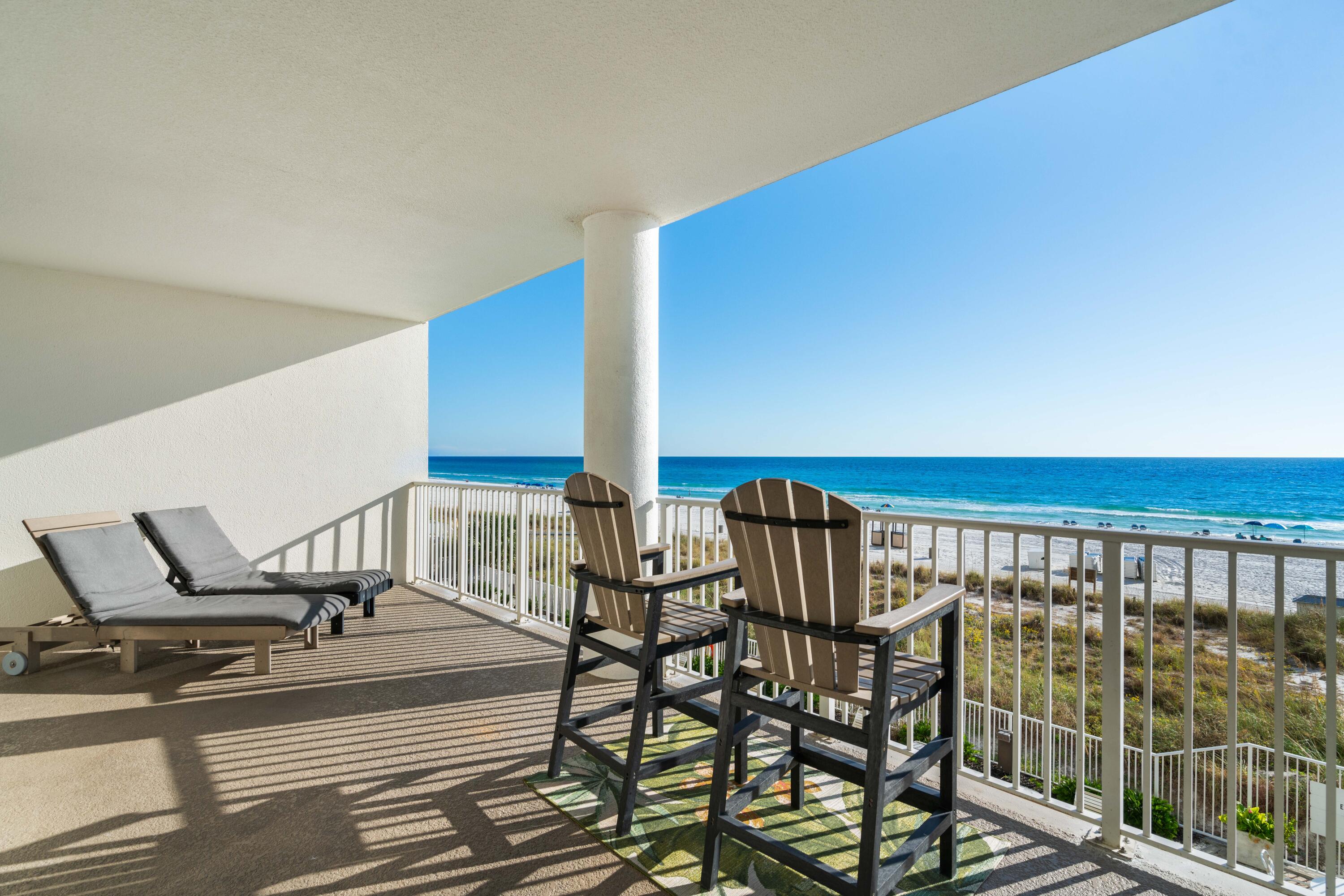 10611 Front Beach Road, Unit 303 Panama City Beach, FL 32408 - Photo 22 of 51 a view of a chairs and table on the terrace
