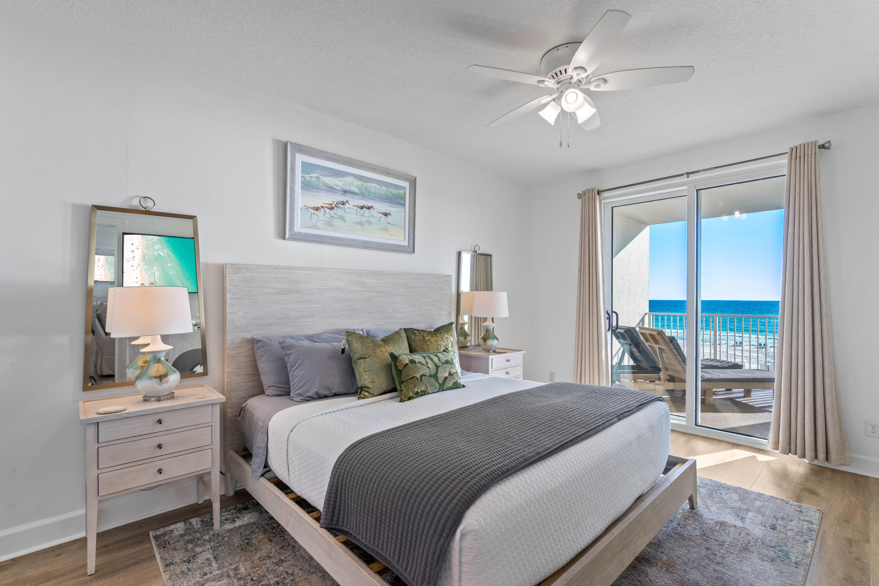 10611 Front Beach Road, Unit 303 Panama City Beach, FL 32408 - Photo 25 of 51 a bedroom with a bed and a chandelier