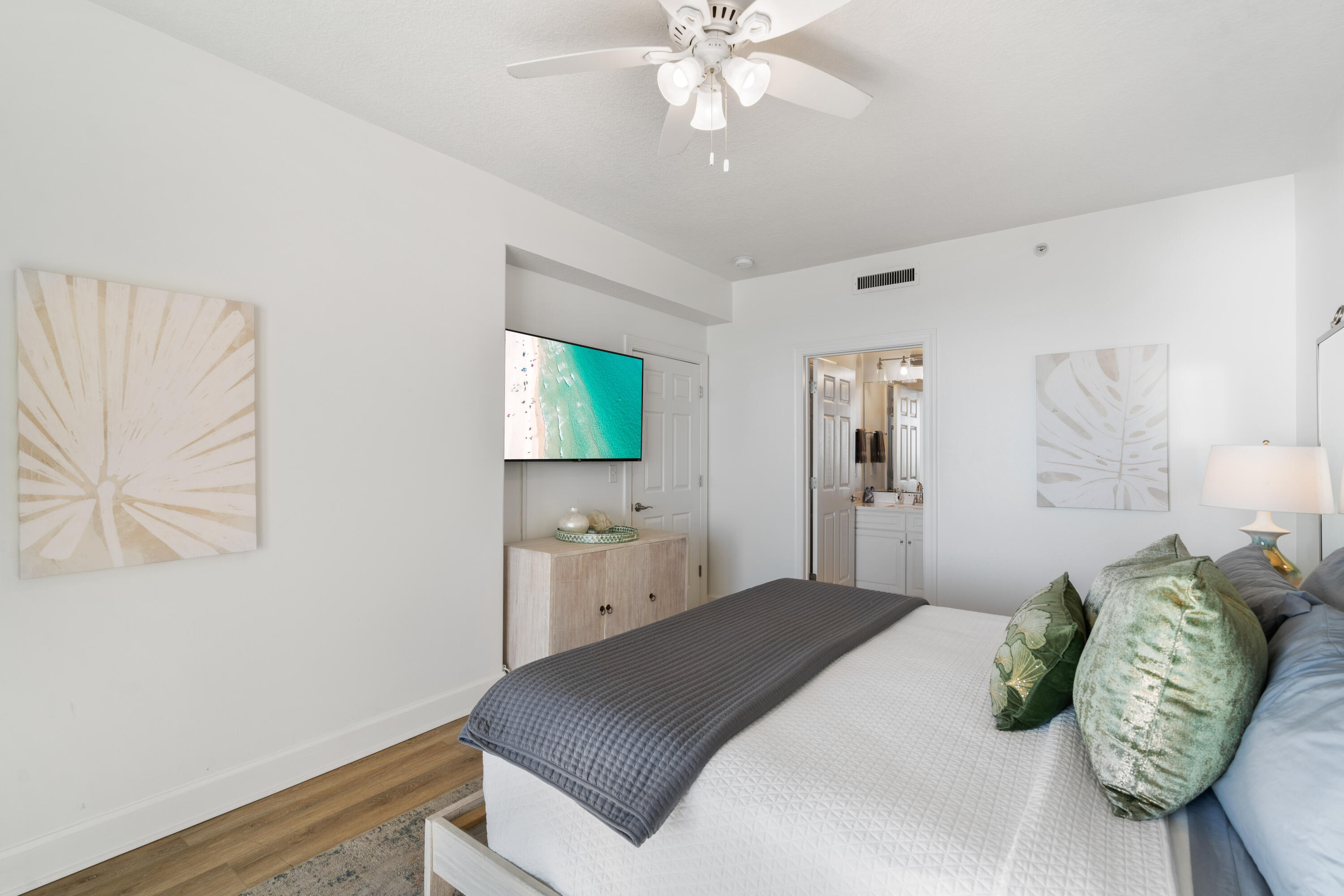 10611 Front Beach Road, Unit 303 Panama City Beach, FL 32408 - Photo 28 of 51 a bedroom with a bed and a chandelier