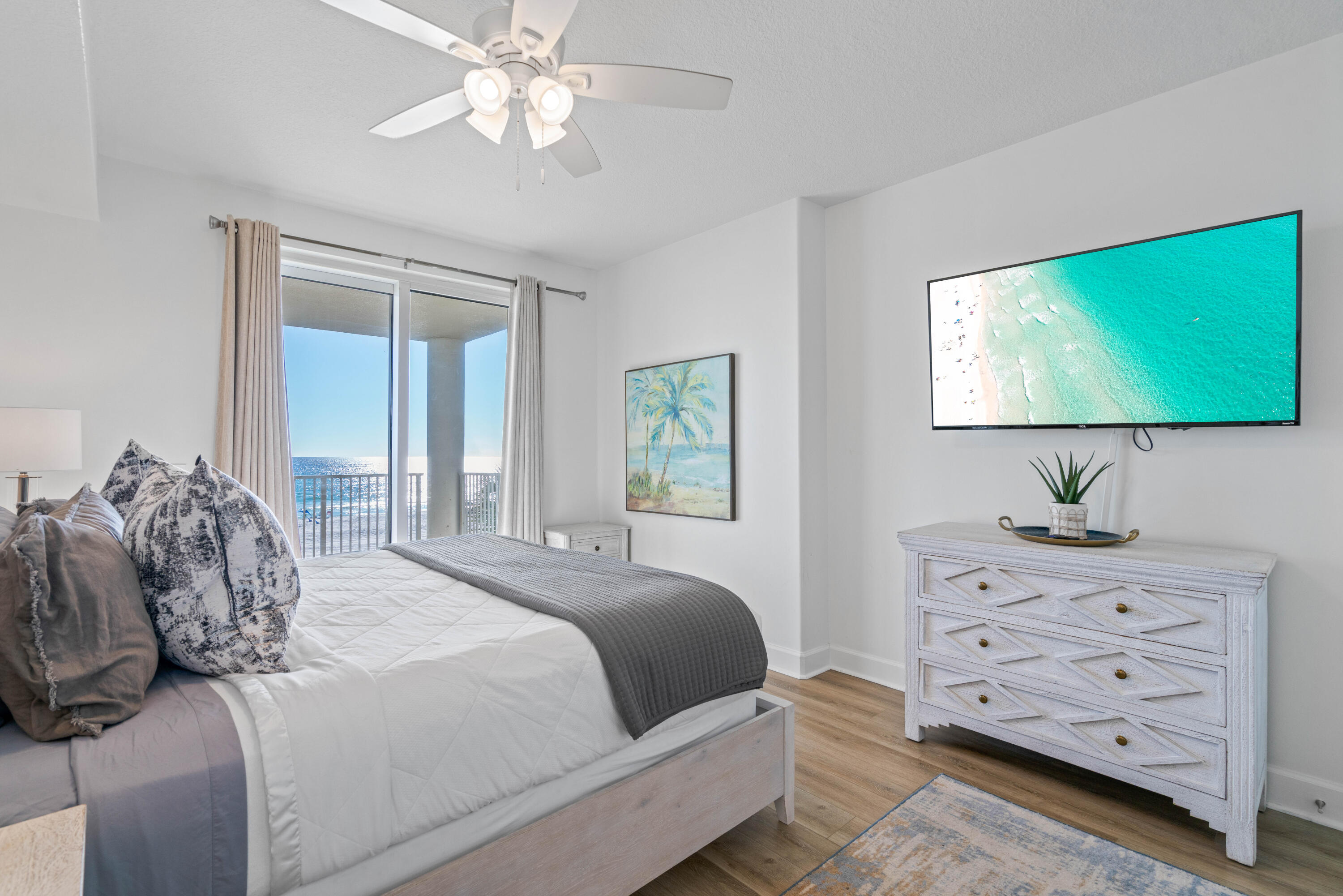 10611 Front Beach Road, Unit 303 Panama City Beach, FL 32408 - Photo 30 of 51 a bedroom with a bed and a flat screen tv