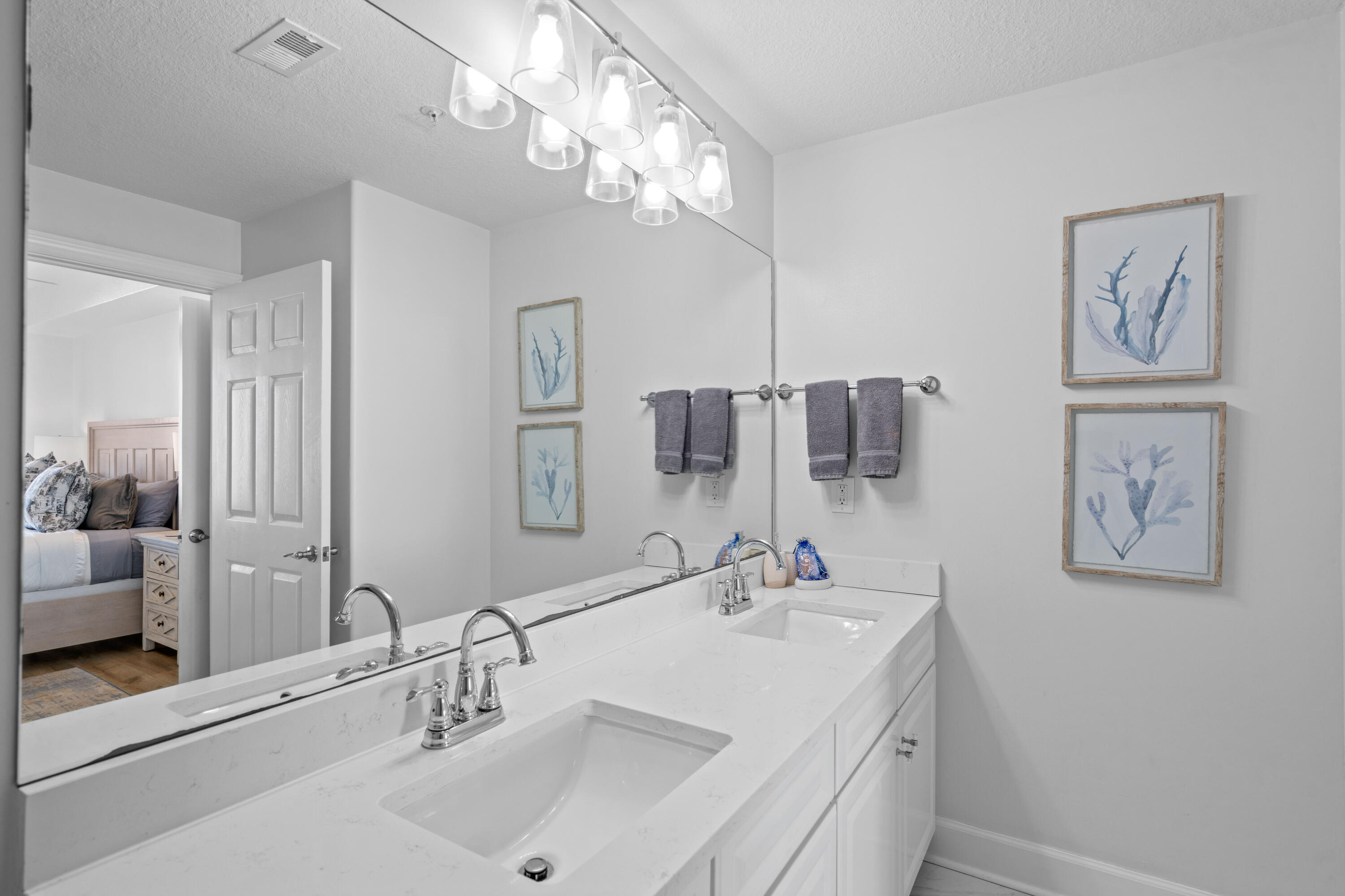 10611 Front Beach Road, Unit 303 Panama City Beach, FL 32408 - Photo 35 of 51 a bathroom with a sink and a mirror