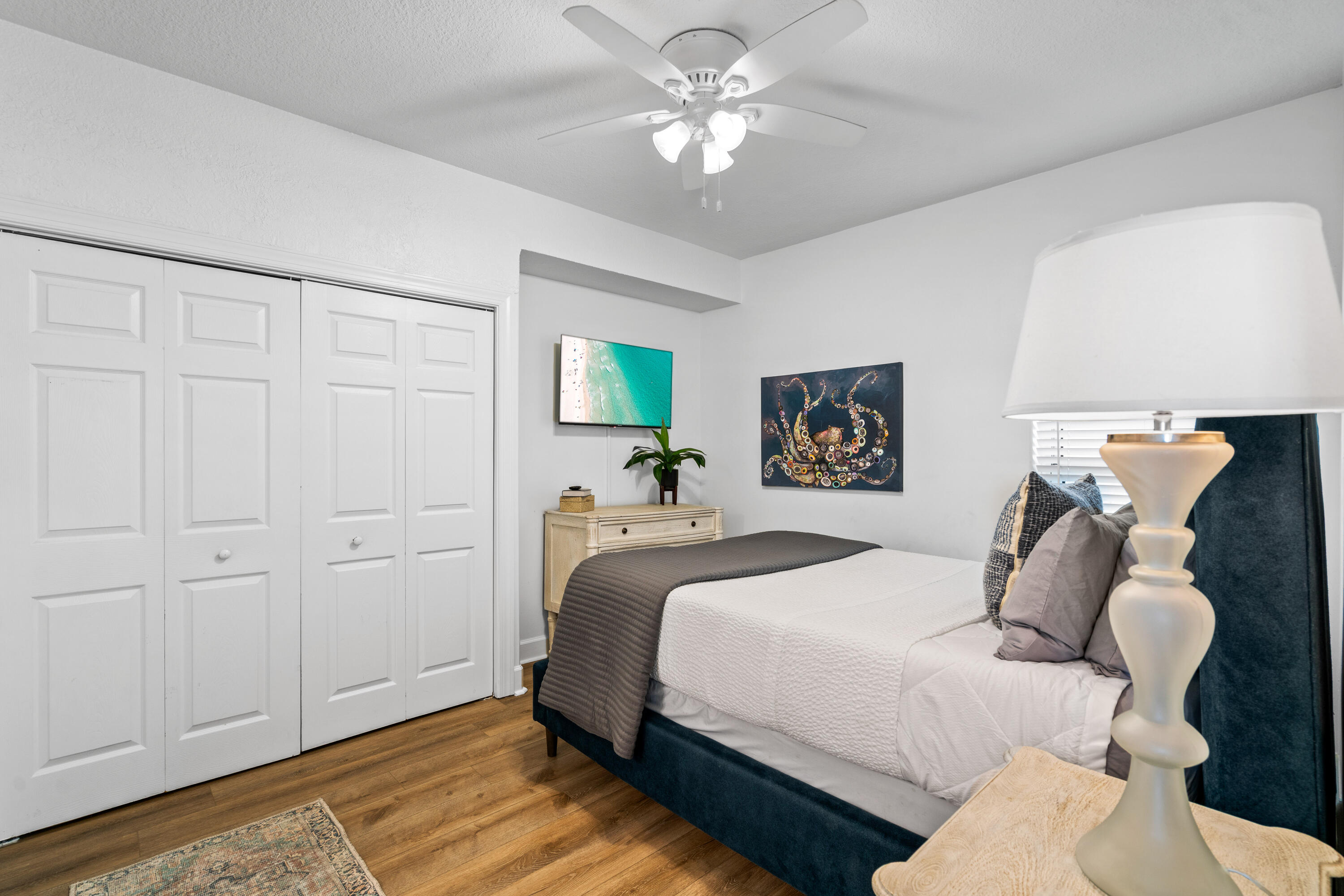 10611 Front Beach Road, Unit 303 Panama City Beach, FL 32408 - Photo 36 of 51 a bedroom with bed and a chandelier