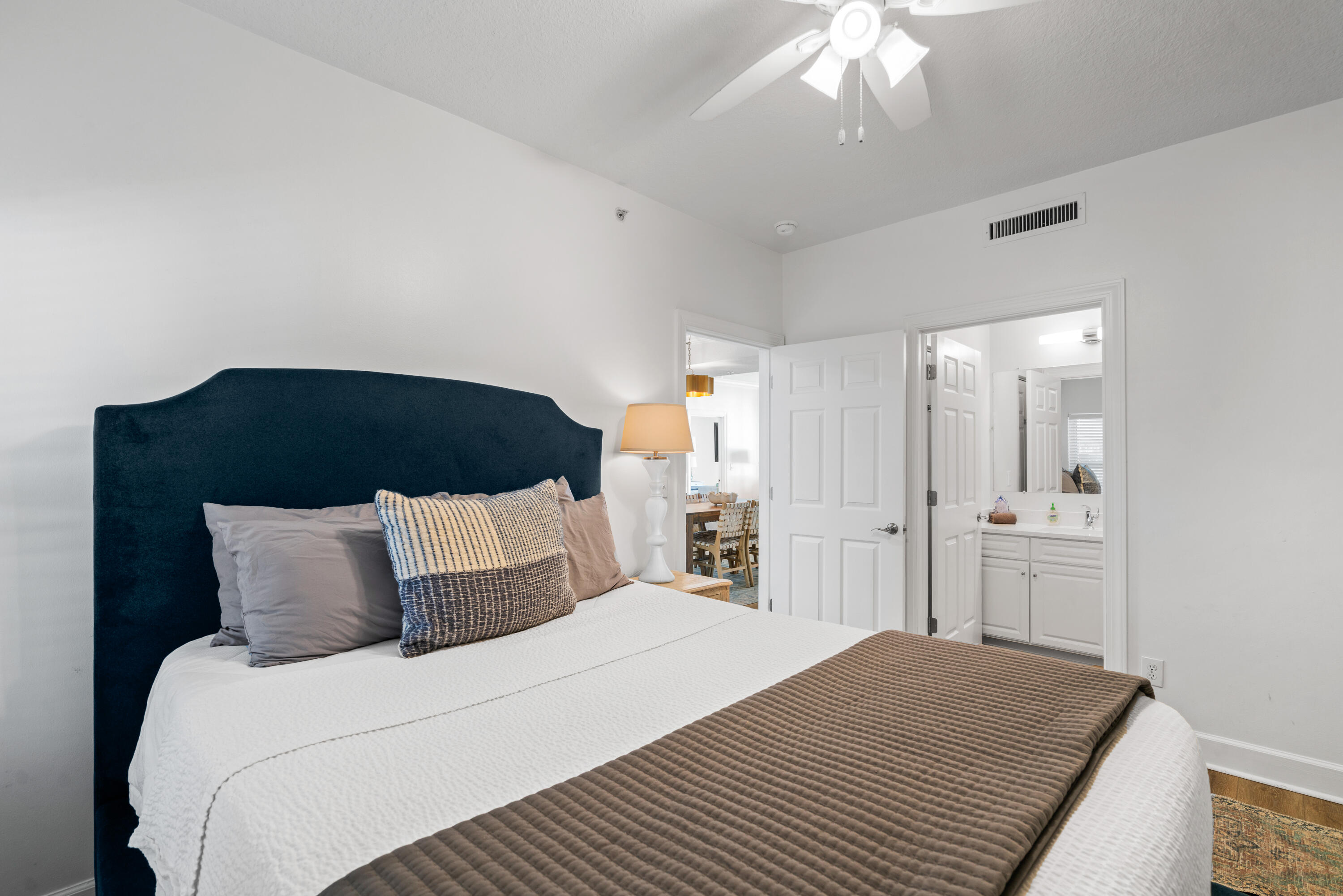 10611 Front Beach Road, Unit 303 Panama City Beach, FL 32408 - Photo 38 of 51 a bedroom with a bed and a chandelier