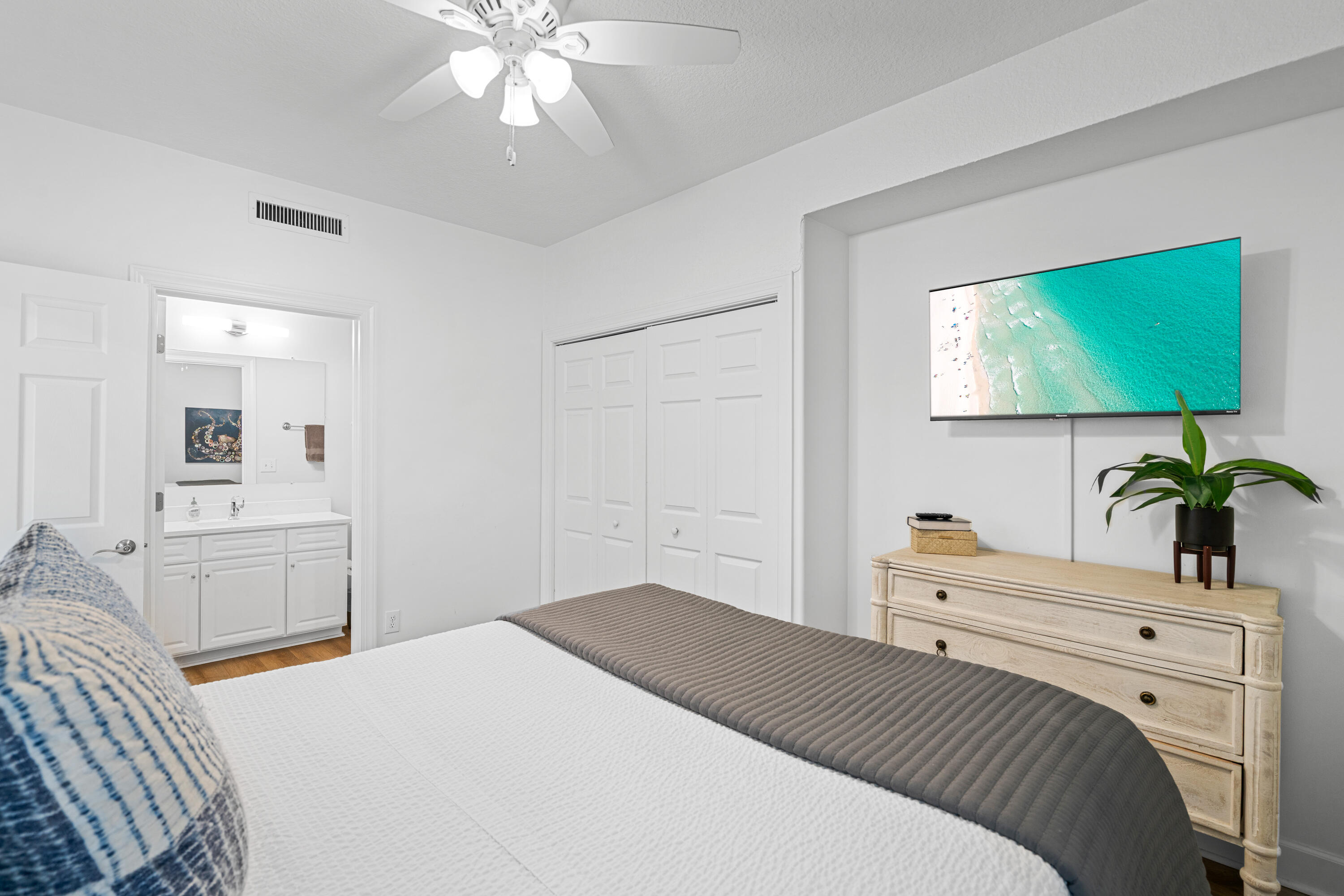 10611 Front Beach Road, Unit 303 Panama City Beach, FL 32408 - Photo 39 of 51 a bedroom with a bed and a flat screen tv