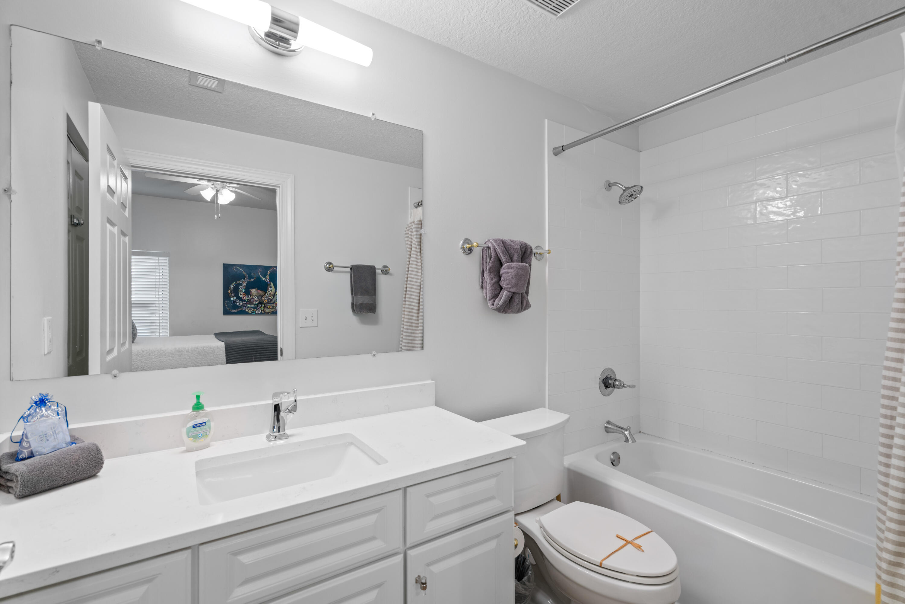 10611 Front Beach Road, Unit 303 Panama City Beach, FL 32408 - Photo 40 of 51 a bathroom with a sink a toilet and shower