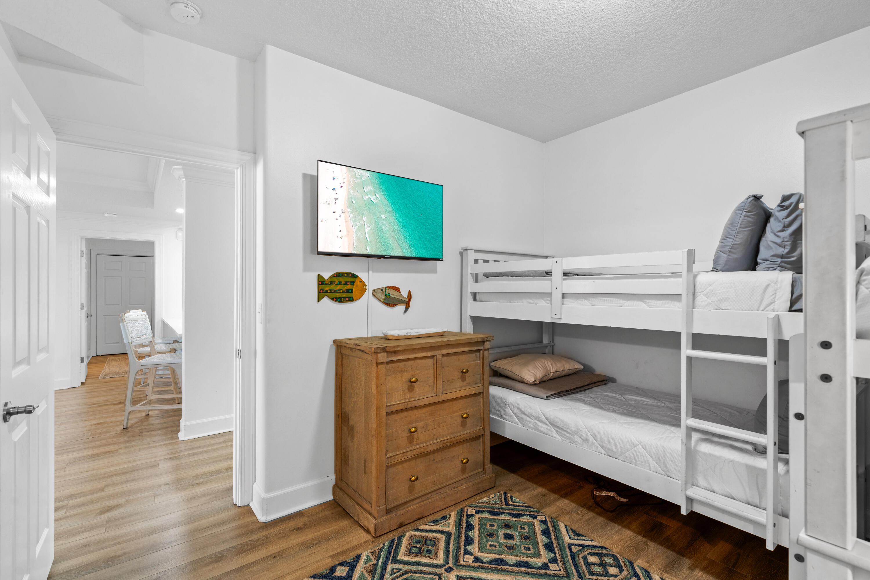 10611 Front Beach Road, Unit 303 Panama City Beach, FL 32408 - Photo 42 of 51 a bedroom with a bed and wooden floor