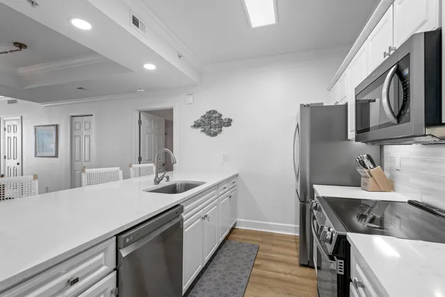 a kitchen with stainless steel appliances a stove microwave sink and refrigerator