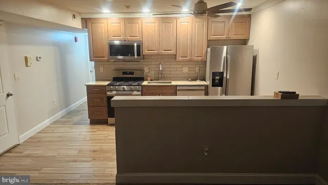 a kitchen with stainless steel appliances a refrigerator and a stove