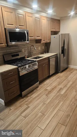 a kitchen with a stove a microwave and refrigerator
