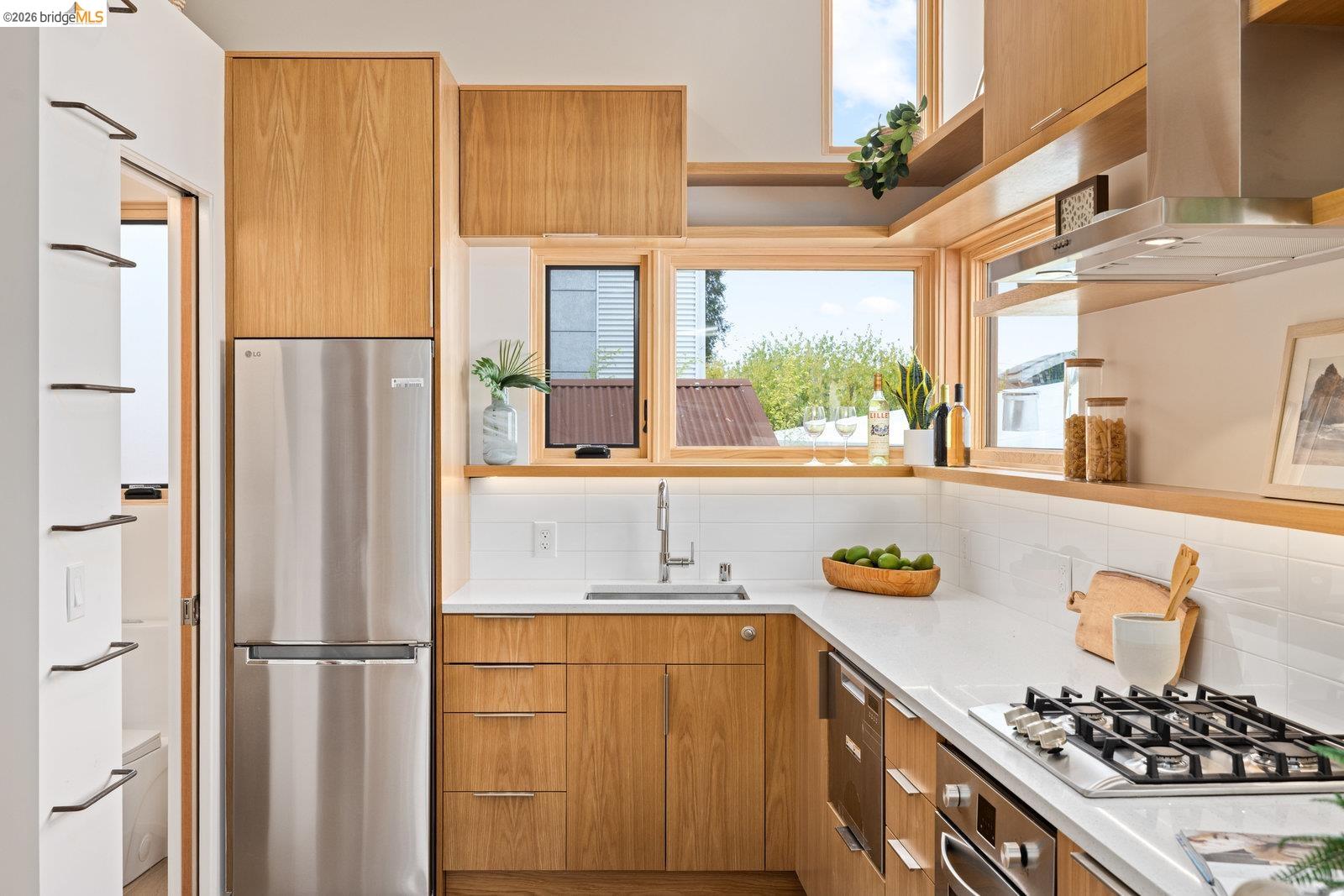 809 Jones Street Berkeley, CA 94710 - Photo 16 of 33 a kitchen with stainless steel appliances granite countertop a refrigerator and a sink