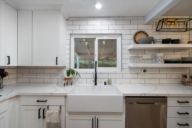 a kitchen with stainless steel appliances a sink and a cabinets