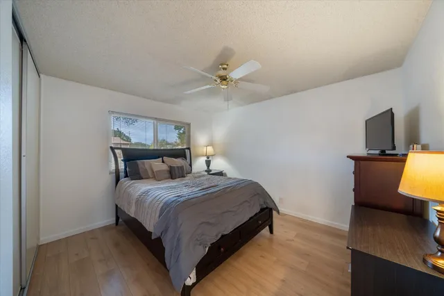 a bedroom with a bed and a flat screen tv