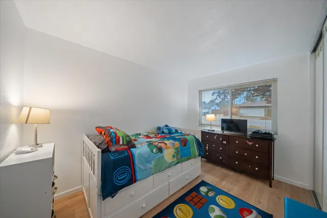 a bedroom with a bed and a window