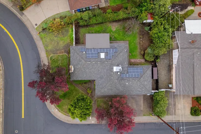 an aerial view of a house with a yard