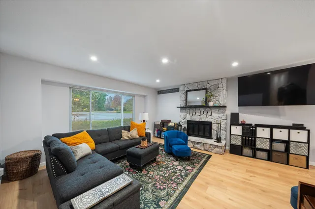 a living room with furniture a flat screen tv and a fireplace
