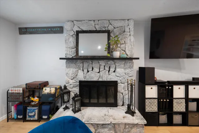 a living room with furniture a flat screen tv and a fireplace