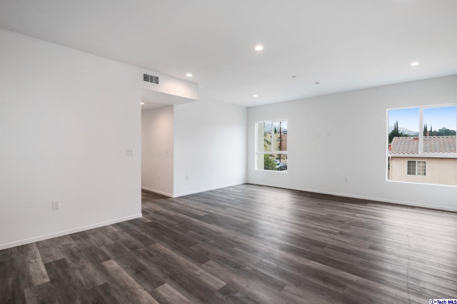 7064 Greeley Street, Unit 202 Tujunga, CA 91042 - Photo 16 of 45 an empty room with wooden floor and windows