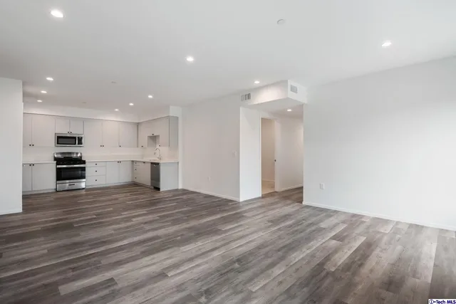 a kitchen with a stove top oven and cabinets