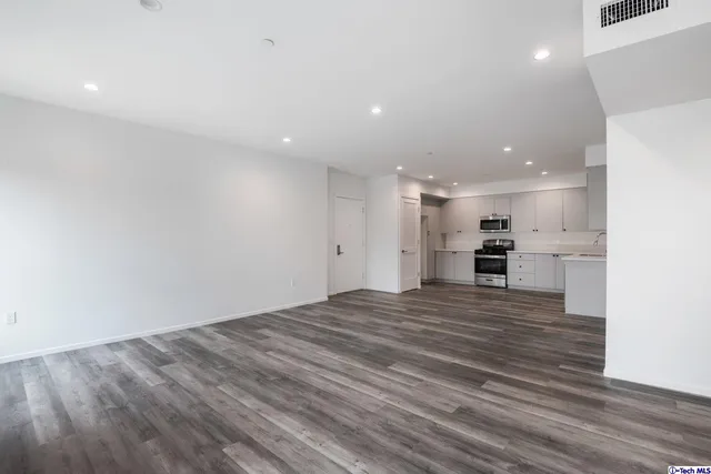 a kitchen with stainless steel appliances a refrigerator and cabinets