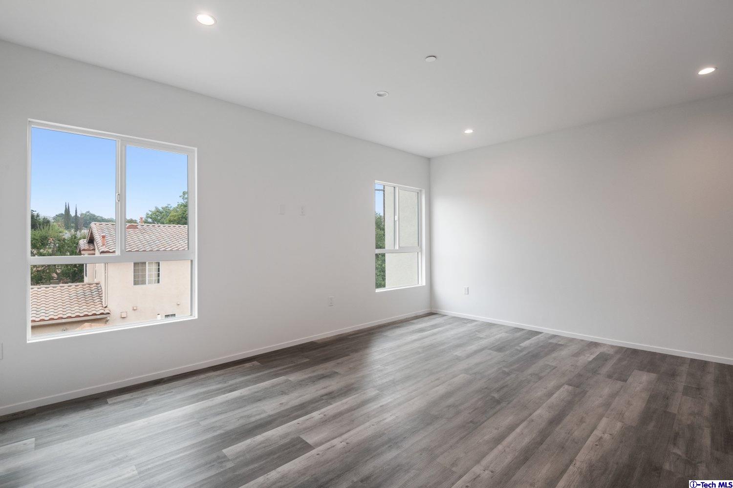 7064 Greeley Street, Unit 202 Tujunga, CA 91042 - Photo 19 of 45 a view of an empty room with wooden floor and a window