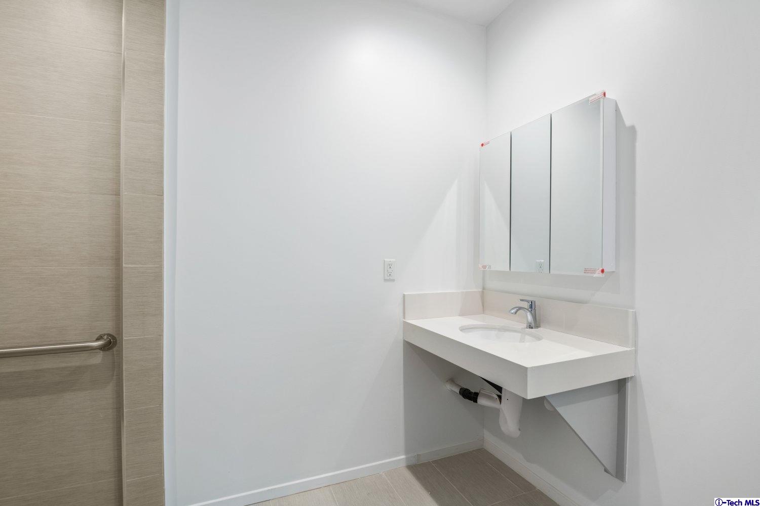 7064 Greeley Street, Unit 202 Tujunga, CA 91042 - Photo 27 of 45 a bathroom with a sink and a mirror
