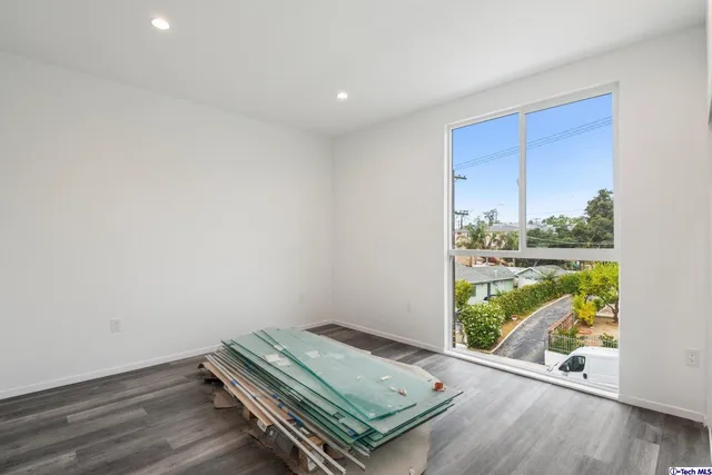 a view of a room with wooden floor
